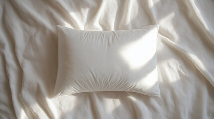 Obraz premium a minimalist, clean top-down view of a soft, rectangular white pillow on smooth white sheets