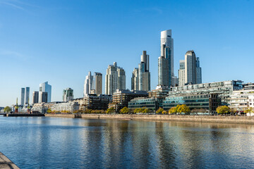 city skyline and buildings near water and shore line in puerto madero, buenos aires, argentina,...