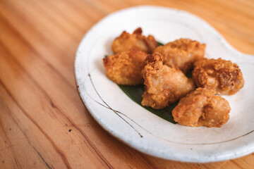 Crispy fried chicken pieces served on a decorative plate.