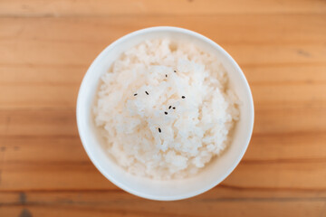 Bowl of cooked japanese rice with black sesame seeds
