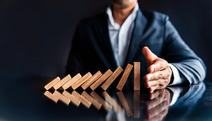 businessman’s hand stops a falling domino, symbolizing control and strategy in a fast-paced environment. The modern table reflects a sleek workspace, highlighting the importance of decisive action in 