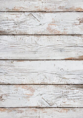 White wood planks arranged in a textured pattern, emphasizing the clean lines and natural beauty of the wood grain. Destroyed surface. 