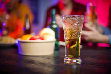 In a late-night office party, a group of Asian men gathers with beer glasses, surrounded by stacks of paper, celebrating and unwinding after a long workday, blending fun and professionalism.
