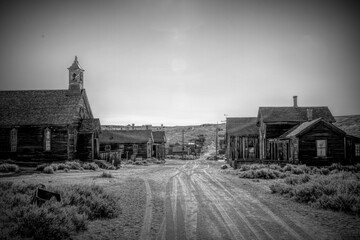 Bodie, California, a historic ghost town, offers a glimpse into the Old West with its abandoned buildings and desolate streets. Once a bustling mining town, it now stands as a preserved relic.