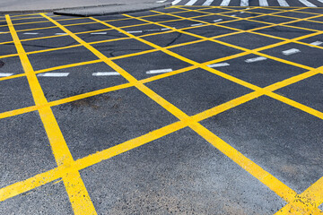 no parking area. yellow grid lines marking on asphalt road.