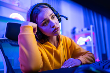 Caucasian young esport woman gamer play online video game on computer.  © Kawee