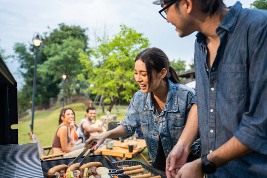 Group of diverse friend having outdoors camping party together in tent. 