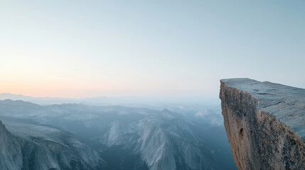 Stunning mountain view with a dramatic cliff edge at sunset.