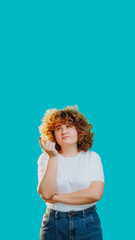 Thoughtful woman thinking looking puzzled clueless uncertain contemplative isolated on blue empty space background.