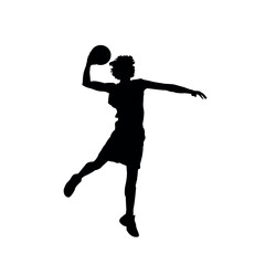 Silhouette of a basketball player in the air about to score a basket