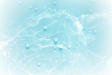Obraz premium Blue water with ripples on the surface. Defocus blurred transparent blue colored clear calm water surface texture with splashes and bubbles. Water waves with shining pattern texture background.