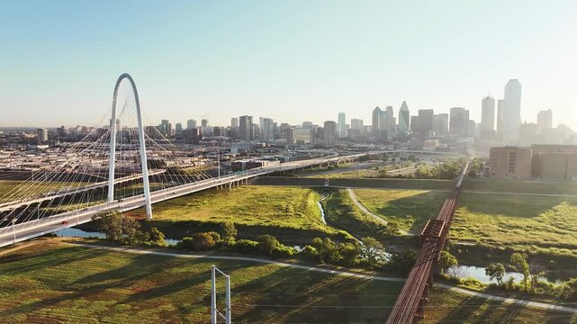 Aerial video of the Margaret Hunt Hill Bridge in downtown Dallas, Texas on a beautiful clear blue sky morning