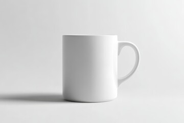 Obraz premium White ceramic mug with a handle, on a white background.