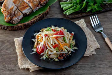 Som Tum Thai - Papaya Salad on the wooden table