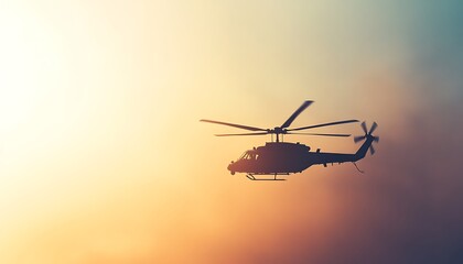 Fototapeta na wymiar Helicopter Silhouette Against a Warm Sunset Sky