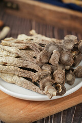 dried lyophyllum decastes on wooden table.