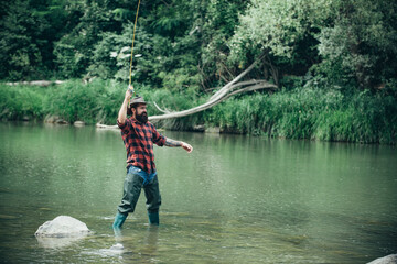 Fisherman man on river or lake with fishing rod.