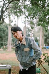 Southeast Asian man striking a pose, showcasing confidence and style.