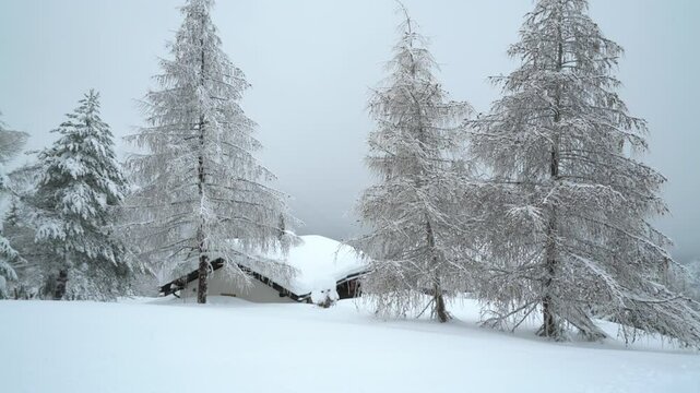 Snow-covered mountain hut in the Alps of ROSSWALD in Switzerland - static shot