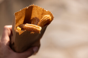 A handful of freshly fried churros on a street background of Mazamitla, Jalisco, Mexico.