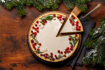 Christmas cake adorned with berries and rosemary