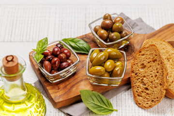 An assortment of various olives presented in a bowl, showcasing different colors, textures, and flavors