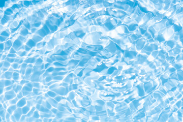 Blue water with ripples on the surface. Defocus blurred transparent blue colored clear calm water surface texture with splashes and bubbles. Water waves with shining pattern texture background.