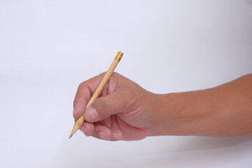 Isolated closeup of a hand holding a pencil to write