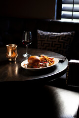 meat lovers burger and fries set in dark ambiance vertical