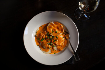 Overhead view of a plate of ravioli covered in sauce