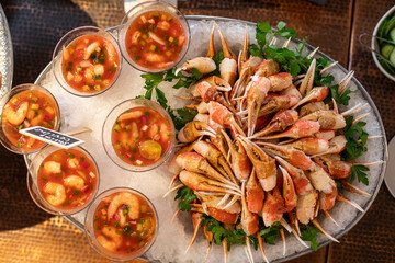 Ceviche cups and crab claws on buffet line