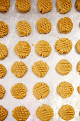 Raw peanut butter cookie dough on sheet pan ready to bake