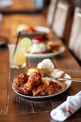 Fried chicken dinner on wooden table vertical