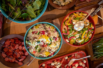Overhead view of a variety of salads at a buffet