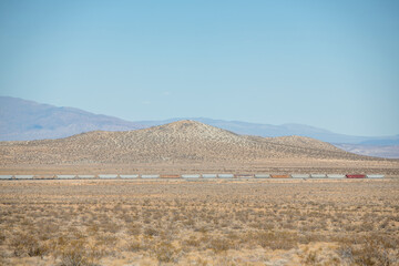 Freight train cars traveling across the southern California desert