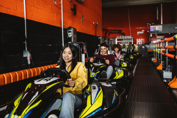 Young Friends Enjoying a Fun Go-Kart Racing Experience © PintoArt