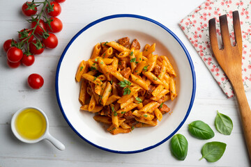 Italian macaroni with chorizo ​​and tomato sauce. Top view table with  decorations.
