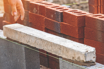 Building strong foundation with concrete and bricks at  construction site during a sunny afternoon