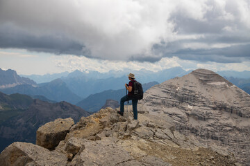 Hiker enjoys the view from Tofana di Mezzo in the italian Dolomites.