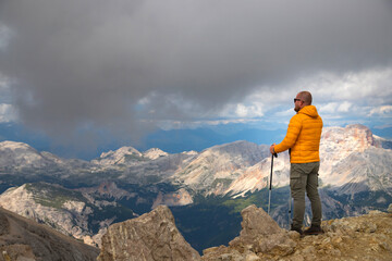 Fototapeta premium Hiker enjoys the view from Tofana di Mezzo, in the italian Dolomites.