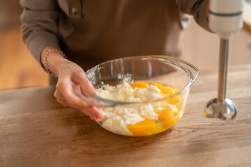 Whipping fresh eggs and cream together in a cozy kitchen for a delicious homemade dessert