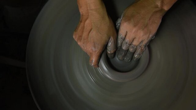 Using a potter's wheel to shaping the cray body by pressed squeezed and pulled gently upwards and outwards into a hollow shape.