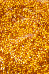 French Dijon mustard background, close-up, top view.