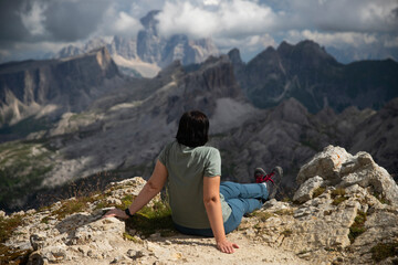 Hiker woman enjoys the view from Lagazuoi mountain over the italian Dolomites.