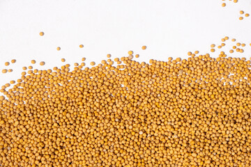 Mustard seeds on white background, natural organic seasoning, top view.