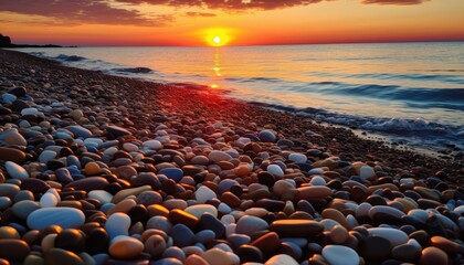 Obraz premium Sunset view on the beach full of pebbles