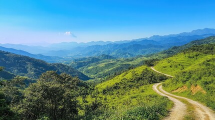 Fototapeta premium A winding mountain route leading through lush green hills, with a breathtaking view of valleys and distant peaks under a clear blue sky.
