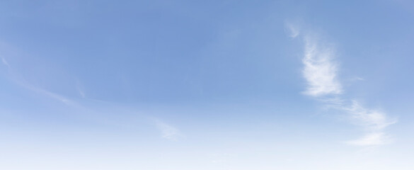 Fototapeta premium The clear blue sky with white clouds provides a bright and sunny background, enhancing the natural beauty of the landscape on this pleasant summer day