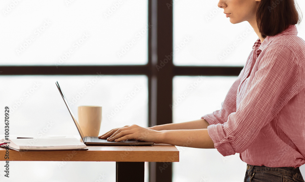 Poster working on project concept. side view close up of young business woman's hands using laptop at moder