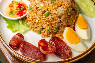 Thai Spicy Shrimp Paste Fried Rice with Served with eggs, sausage, cucumber and lettuce,Popular Asian Food